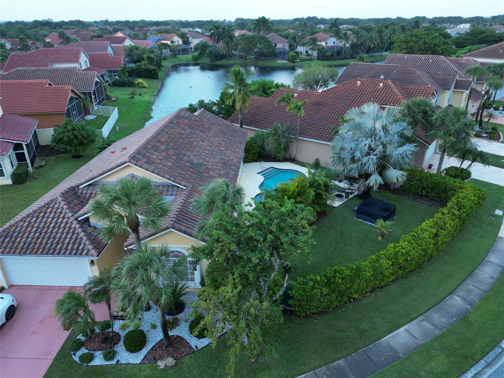 an aerial view of a house with garden space and lake view