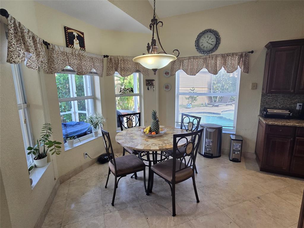 22112 Altona Drive Boca Raton, FL 33428 - Photo 12 of 40 a view of a dining room with furniture window and wooden floor