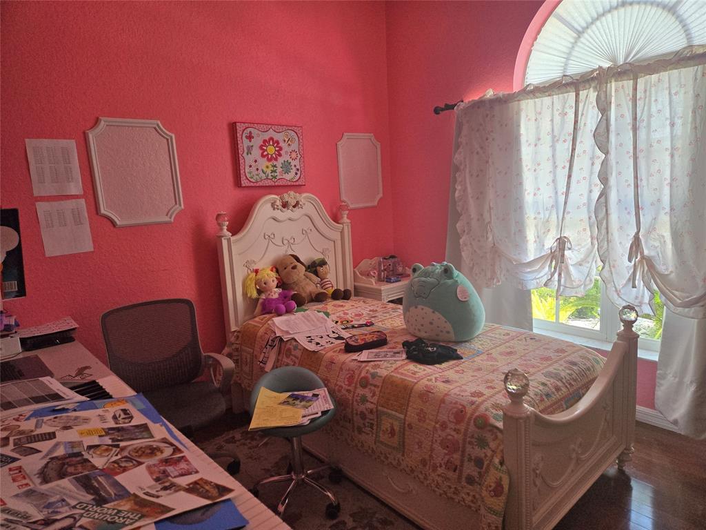 22112 Altona Drive Boca Raton, FL 33428 - Photo 19 of 40 a bed sitting in a bedroom next to a window