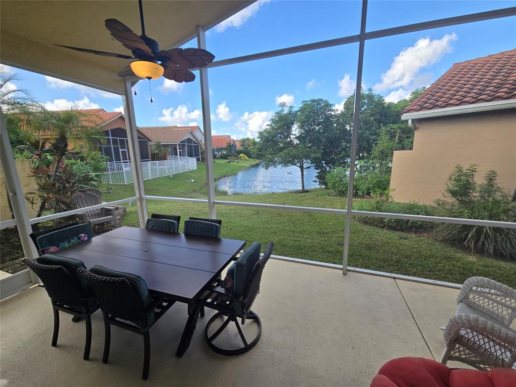 22112 Altona Drive Boca Raton, FL 33428 - Photo 22 of 40 a view of a patio with a table chairs and a small yard