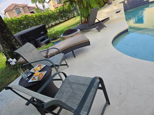 an aerial view of a chairs and table in patio