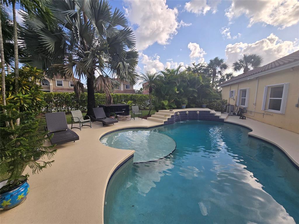 22112 Altona Drive Boca Raton, FL 33428 - Photo 27 of 40 a view of a swimming pool with a yard