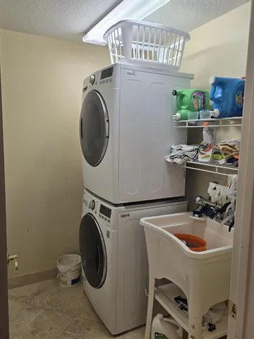 a utility room with sink dryer and washer