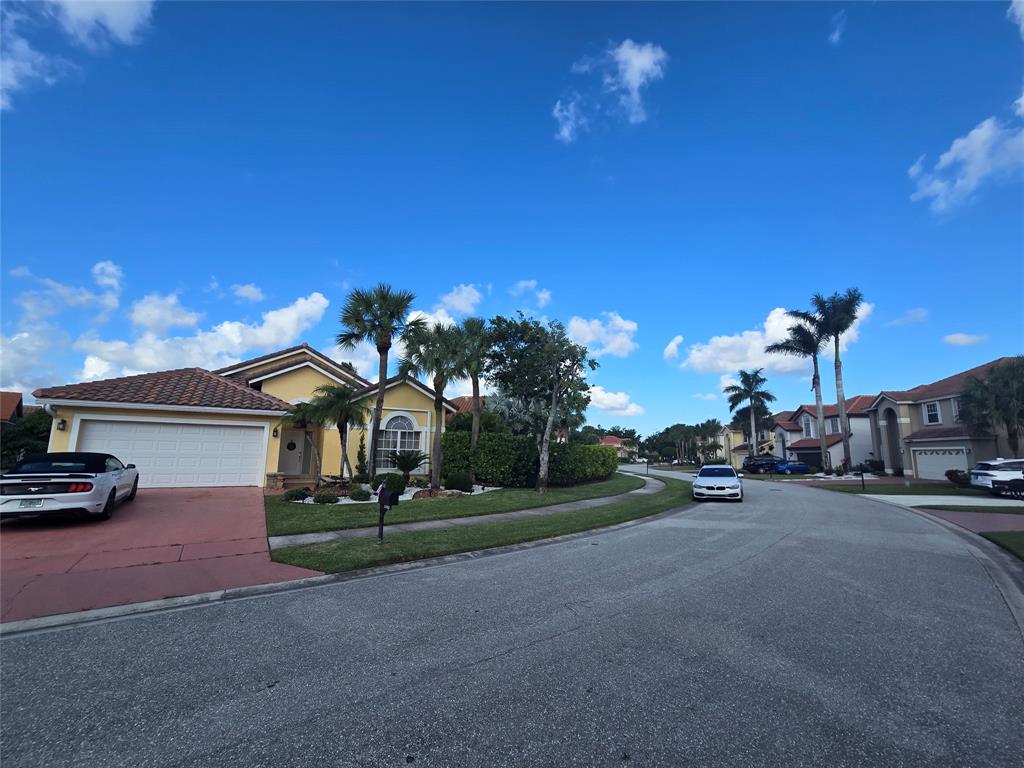 22112 Altona Drive Boca Raton, FL 33428 - Photo 34 of 40 a view of a parked cars in front of a building