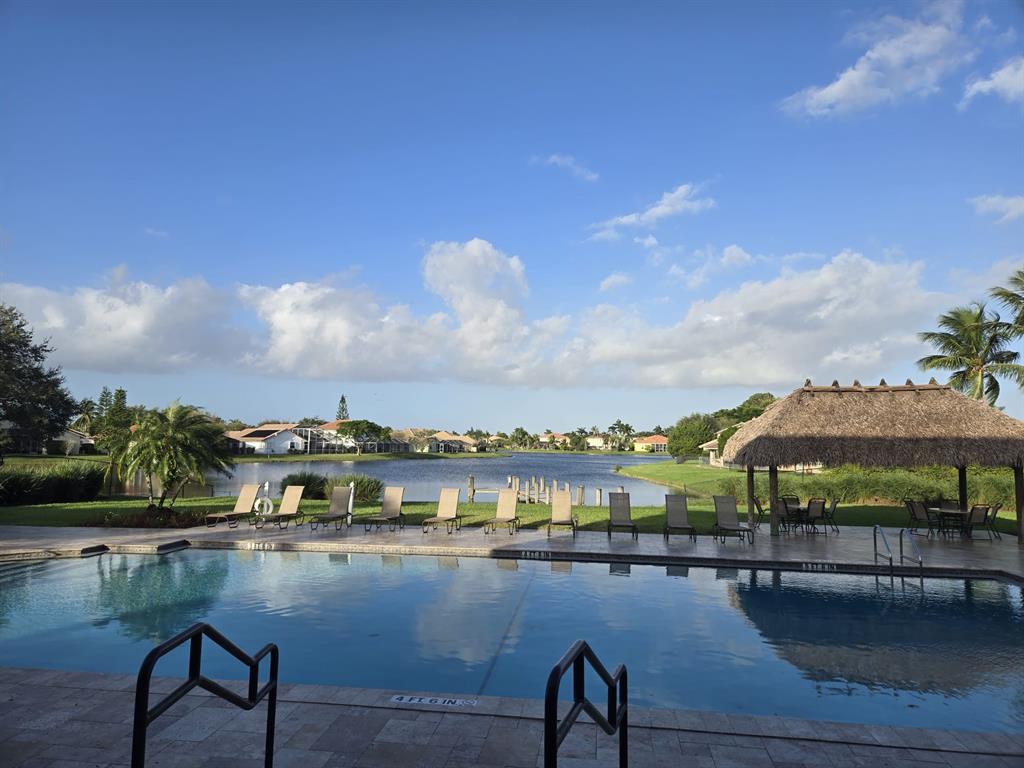 22112 Altona Drive Boca Raton, FL 33428 - Photo 39 of 40 a view of swimming pool with outdoor seating and lake view