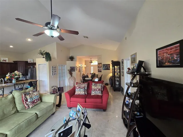 a living room with furniture a flat screen tv and a window