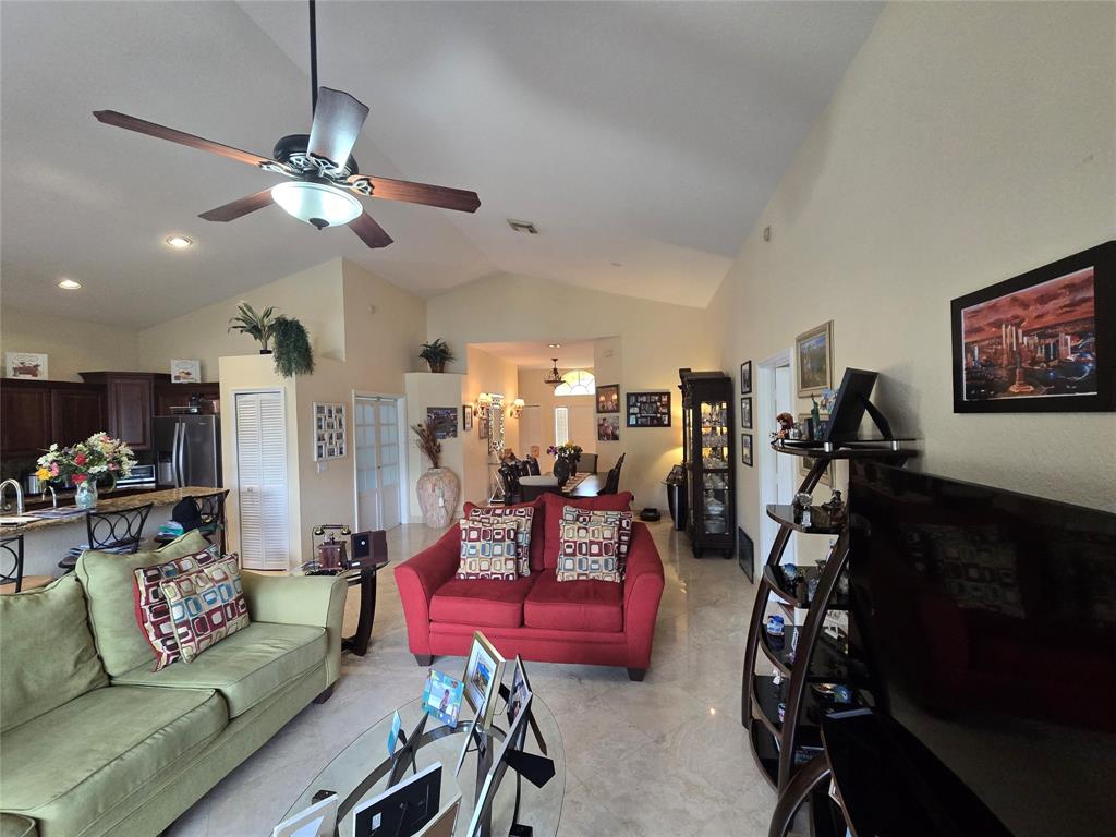 22112 Altona Drive Boca Raton, FL 33428 - Photo 9 of 40 a living room with furniture a flat screen tv and a window
