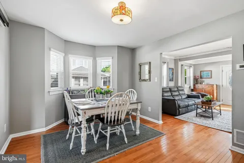 a view of a dining room with furniture and a potted plant