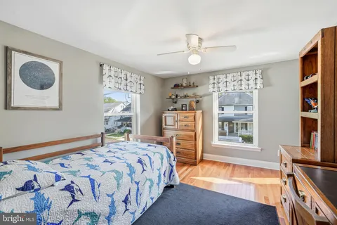 a bedroom with a bed dresser and a window