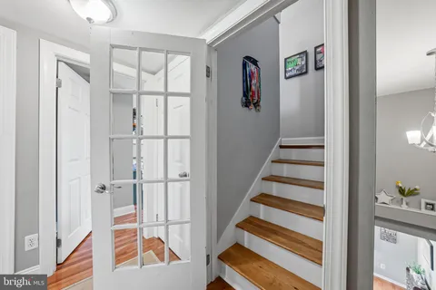 a view of entryway with wooden floor and front door