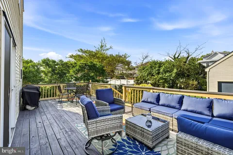 a roof deck with a table and chairs