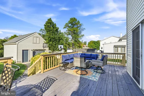 a view of a deck with furniture and a potted plant