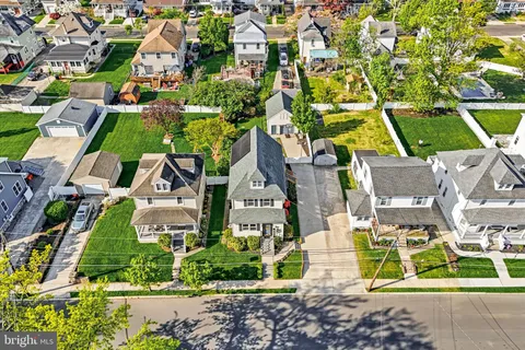 an aerial view of residential houses with outdoor space and street view