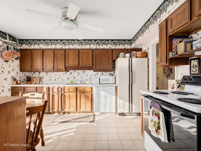 a view of kitchen with stainless steel appliances granite countertop a stove and a refrigerator