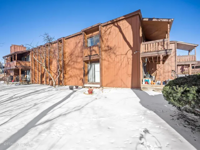 a street view with wooden fence and flowers