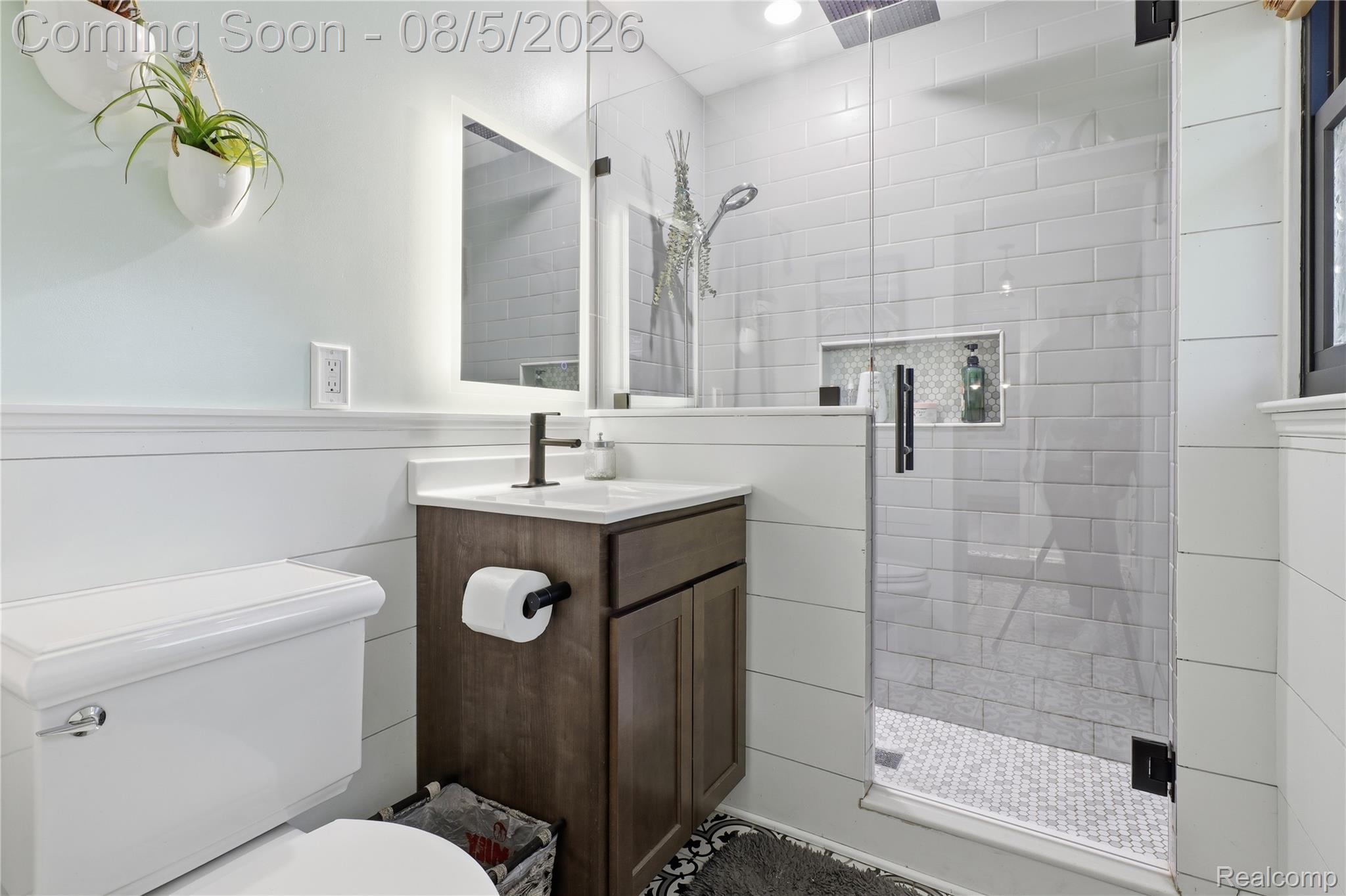 6478 West Stanley Road Mount Morris, MI 48458 - Photo 39 of 80 Bathroom featuring a glass-enclosed shower with subway tile surround, a built-in shower niche, and a contrasting penny tile floor