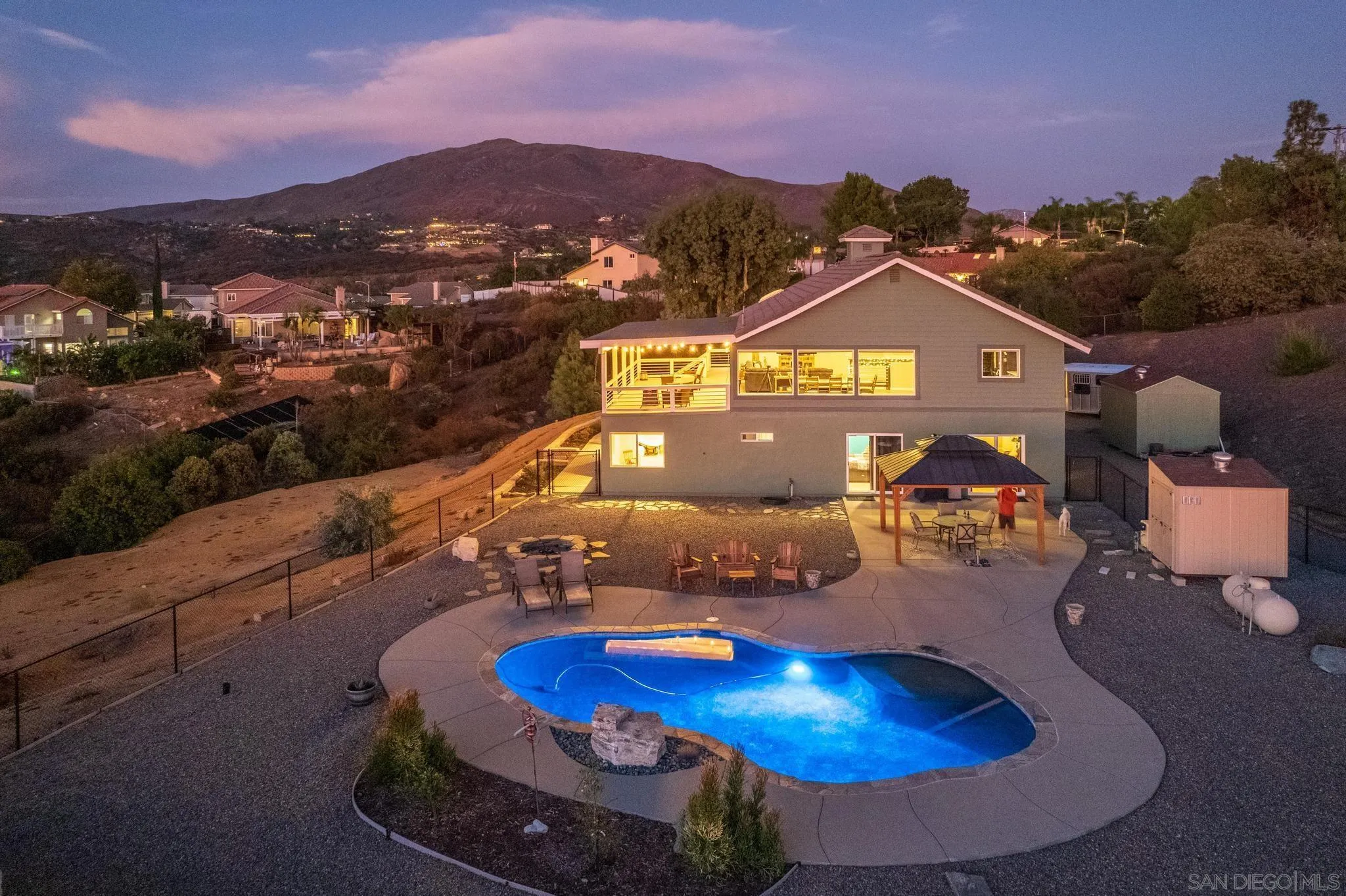 a view of a pool in front of house