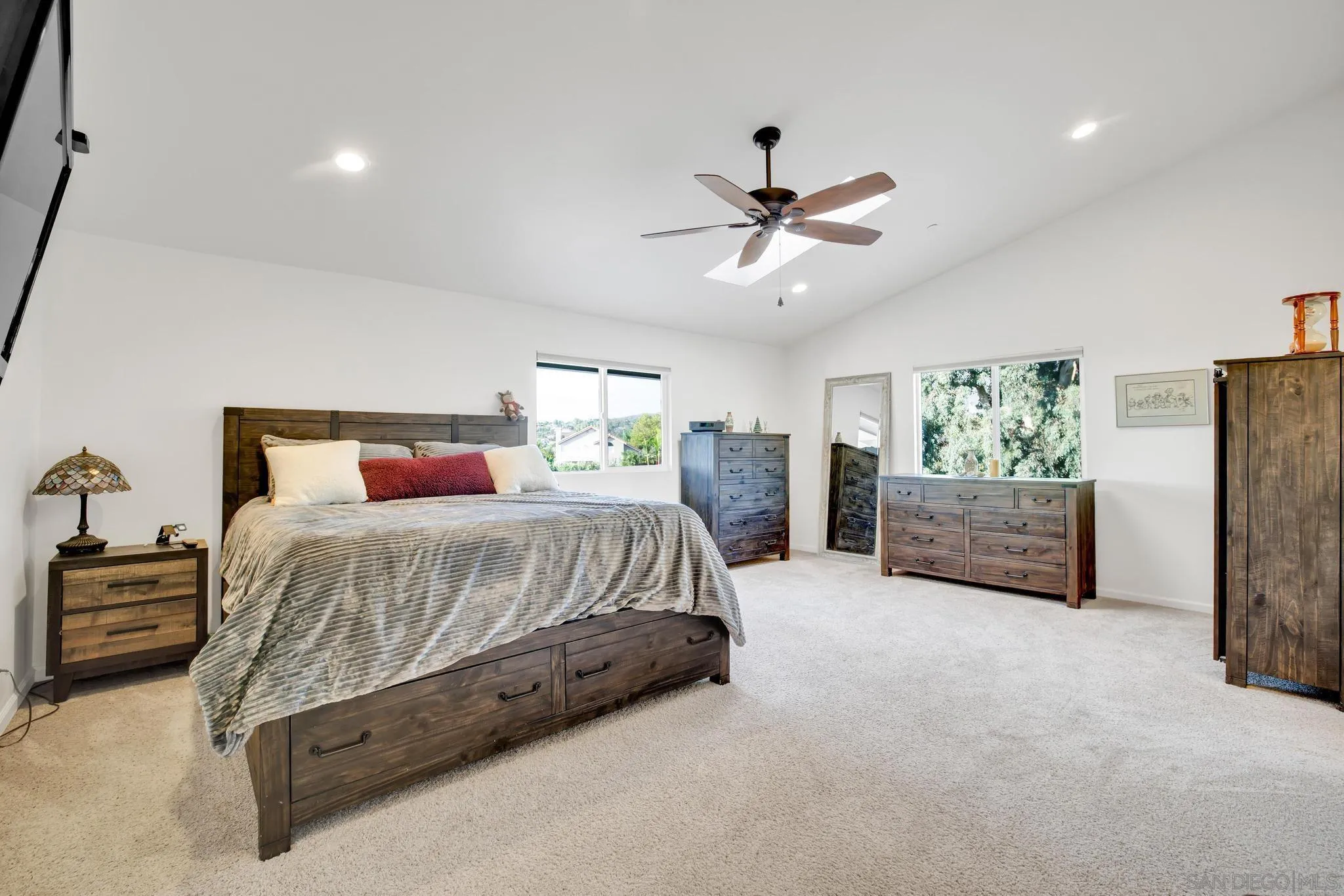 1661 West Winds Ridge Alpine, CA 91901 - Photo 30 of 65 a spacious bedroom with a bed a dresser and a chandelier
