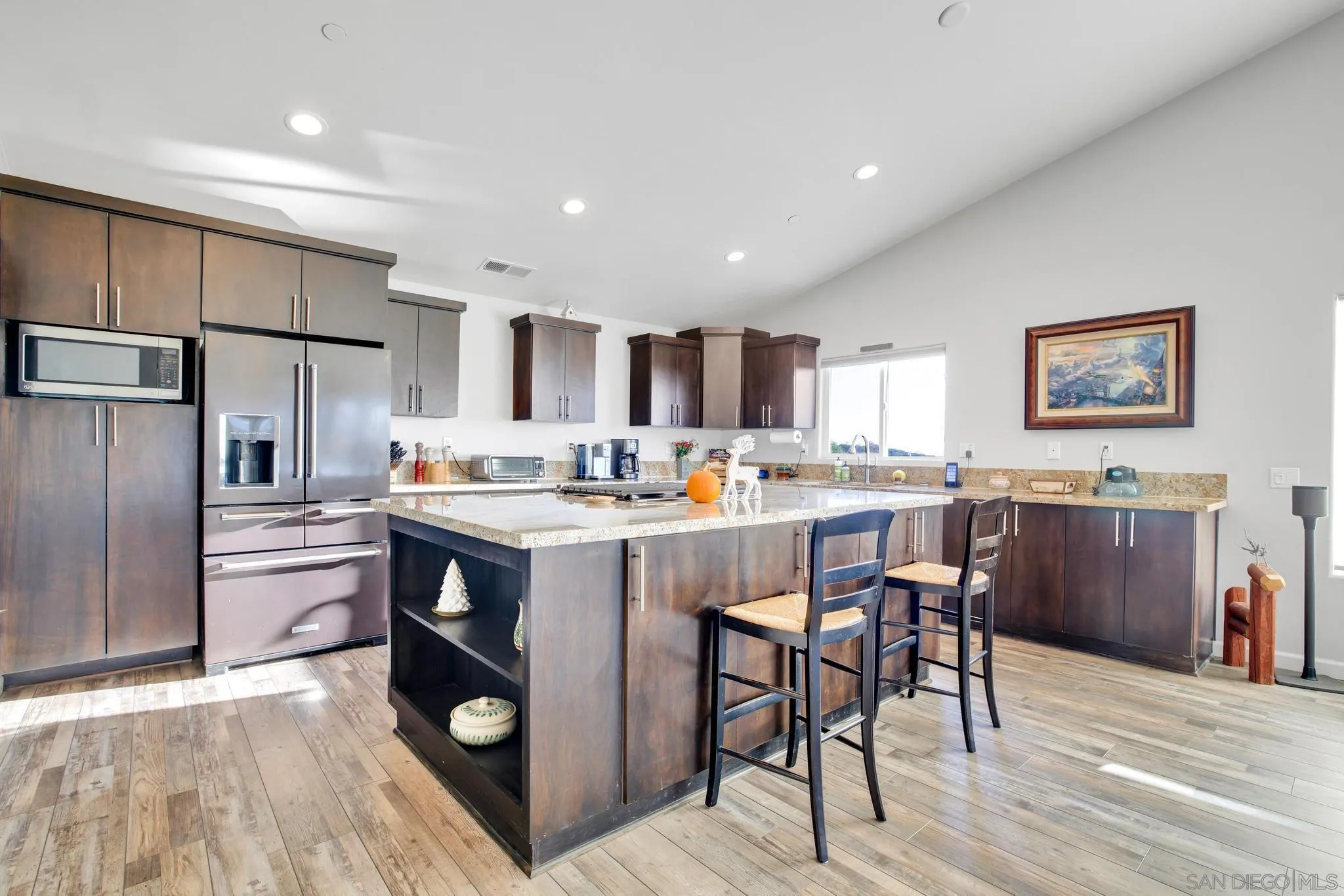 1661 West Winds Ridge Alpine, CA 91901 - Photo 8 of 65 a kitchen with stainless steel appliances granite countertop a refrigerator a stove a sink a dining table and chairs with wooden floor