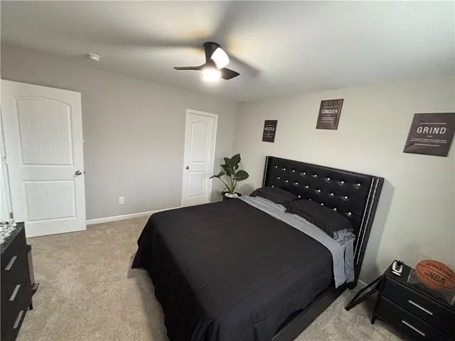 a bedroom with a bed and ceiling fan