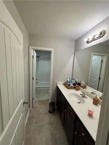 a bathroom with a sink vanity and a mirror