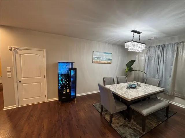 a view of a workspace with furniture and wooden floor