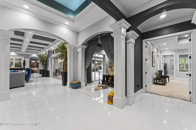 a room with a chandelier and a large mirror