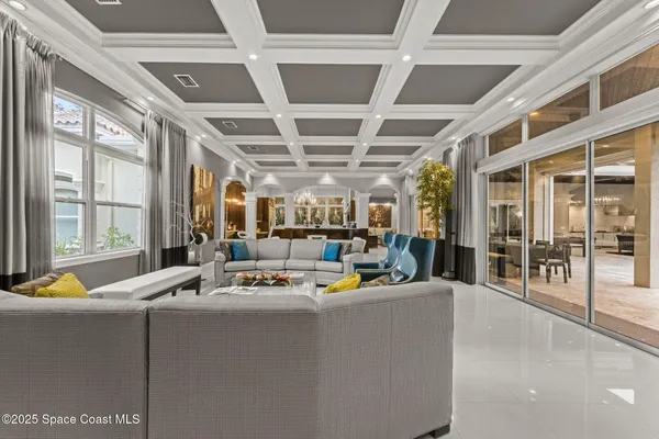 a living room with furniture and a chandelier