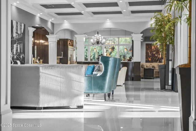 a kitchen with stainless steel appliances granite countertop a stove and a view of living room