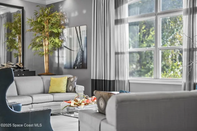 a kitchen with stainless steel appliances granite countertop a stove and a view of living room