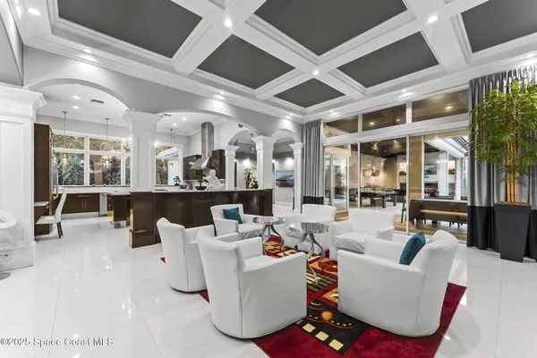 a living room with furniture a ceiling fan and a rug