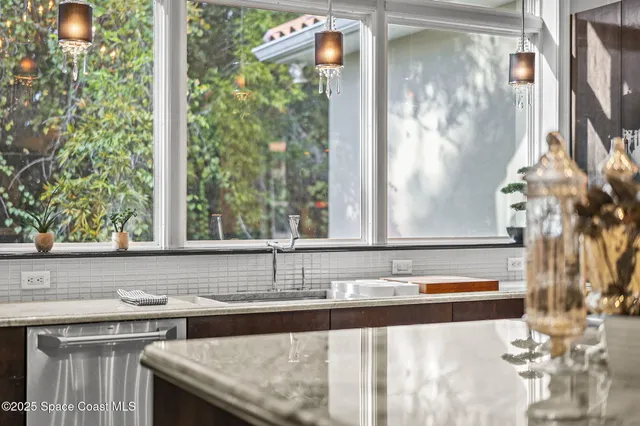 a outdoor space with lots of tables a large window and chairs