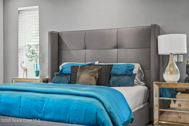 a view of a porch with a table and chairs under an umbrella