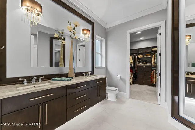 a view of a house with a big yard and palm trees