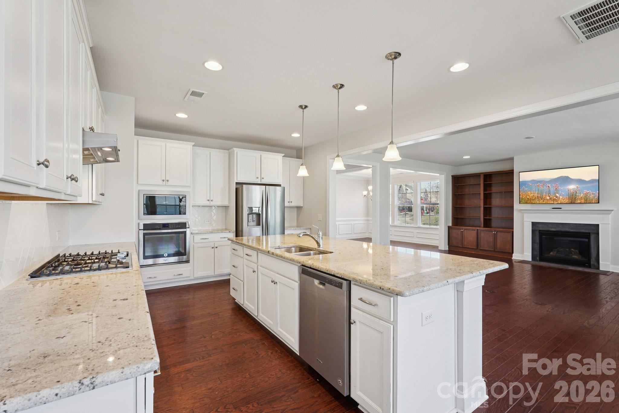 17422 Shearer Road Davidson, NC 28036 - Photo 3 of 48 a kitchen with stainless steel appliances granite countertop a sink refrigerator and cabinets
