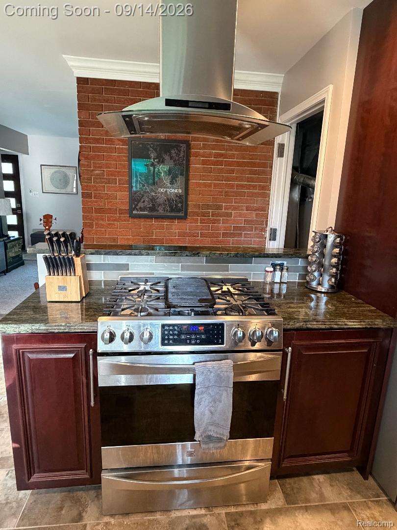 1615 Ladd Road Walled Lake, MI 48390 - Photo 13 of 28 Stainless steel range with a ventilation hood