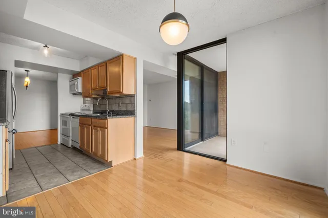 a kitchen with stainless steel appliances a refrigerator and a stove