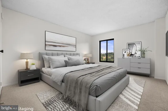 a bedroom with a large bed and a lamp