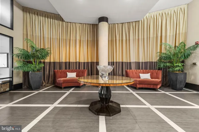 a living room with furniture and a potted plant