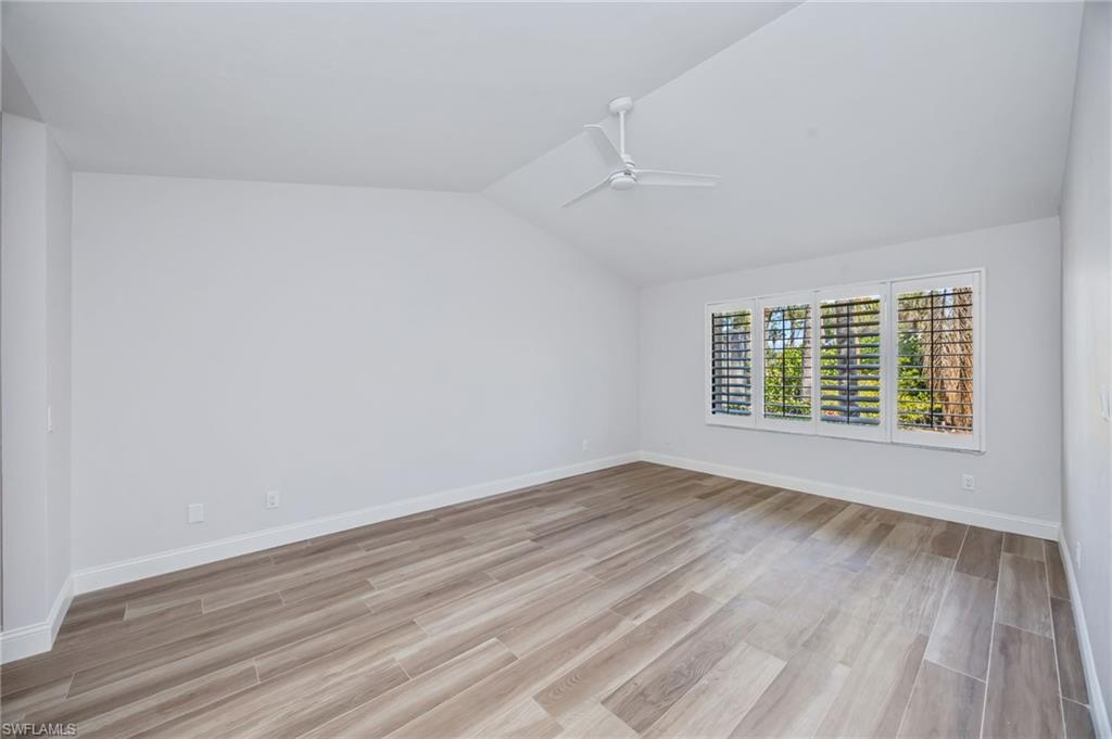 121 Bears Paw Trail Naples, FL 34105 - Photo 12 of 39 wooden floor in an empty room with a window