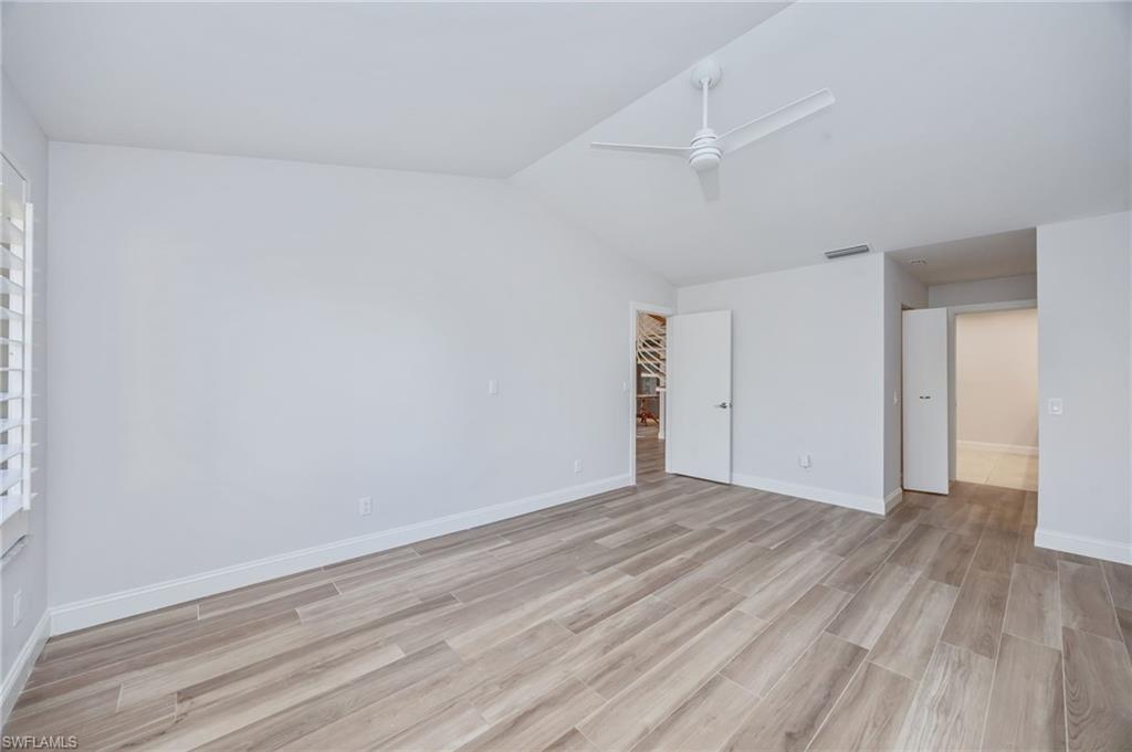 121 Bears Paw Trail Naples, FL 34105 - Photo 14 of 39 a view of an empty room with wooden floor