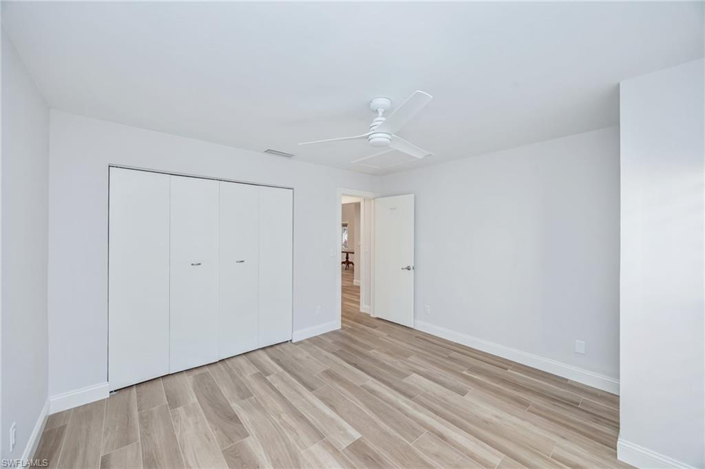 121 Bears Paw Trail Naples, FL 34105 - Photo 18 of 39 a view of an empty room with wooden floor