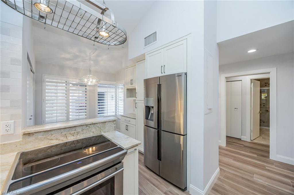 121 Bears Paw Trail Naples, FL 34105 - Photo 24 of 39 a kitchen with a refrigerator and a window