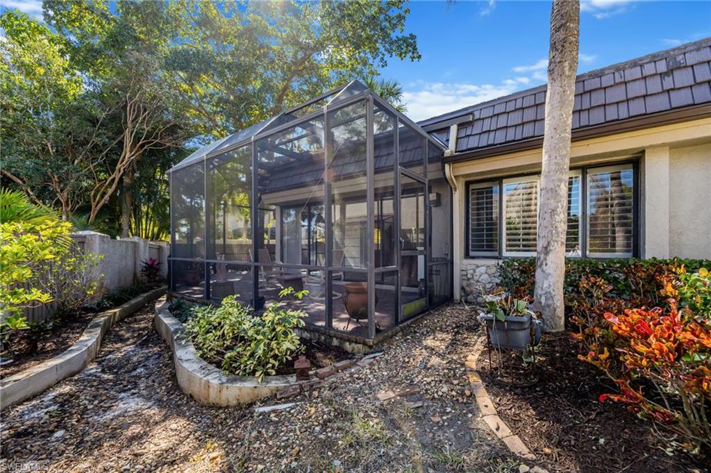 121 Bears Paw Trail Naples, FL 34105 - Photo 29 of 39 a view of a house with a yard and potted plants