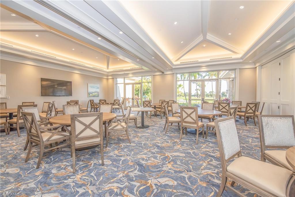 121 Bears Paw Trail Naples, FL 34105 - Photo 37 of 39 a room with lots of tables a large window and chairs