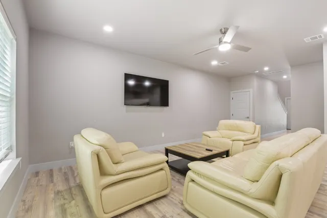 a living room with furniture and a chandelier