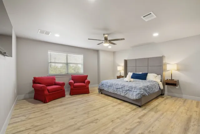 a bedroom with a bed and a couch