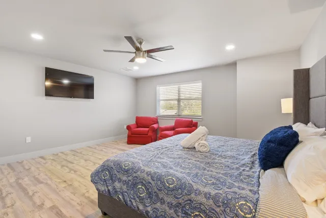 a bedroom with a bed and a flat screen tv