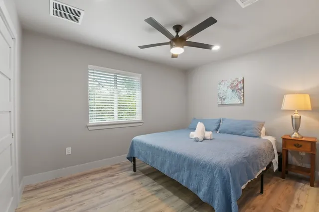 a bedroom with a bed and a painting on the wall