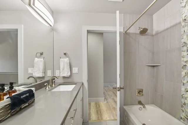 a bathroom with a double vanity sink and mirror